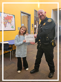 Deputy Horn presenting certificate to winner Aria 